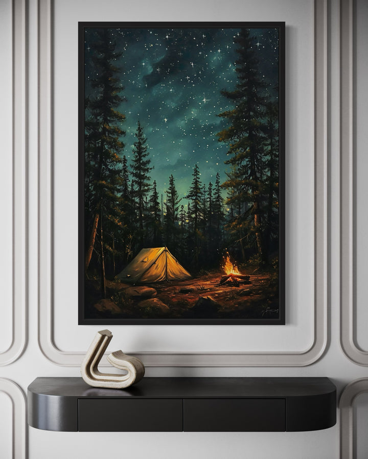 Framed canvas art of a glowing campfire and tent in a pine forest under a starry night sky.