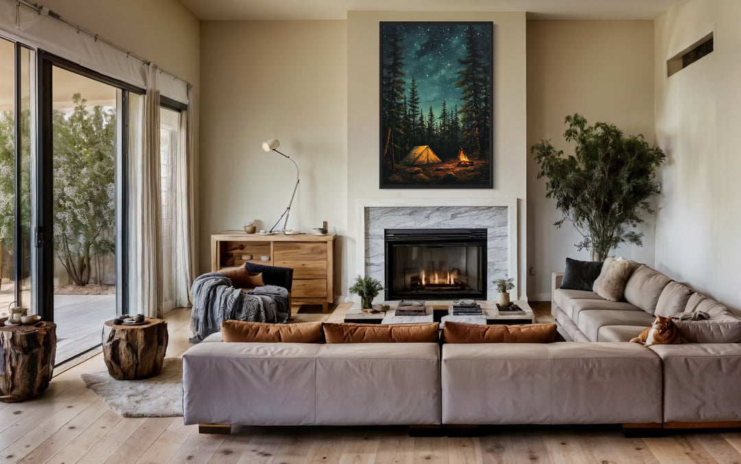 Vertical canvas wall art of a glowing campfire and tent in a starry pine forest above a fireplace.