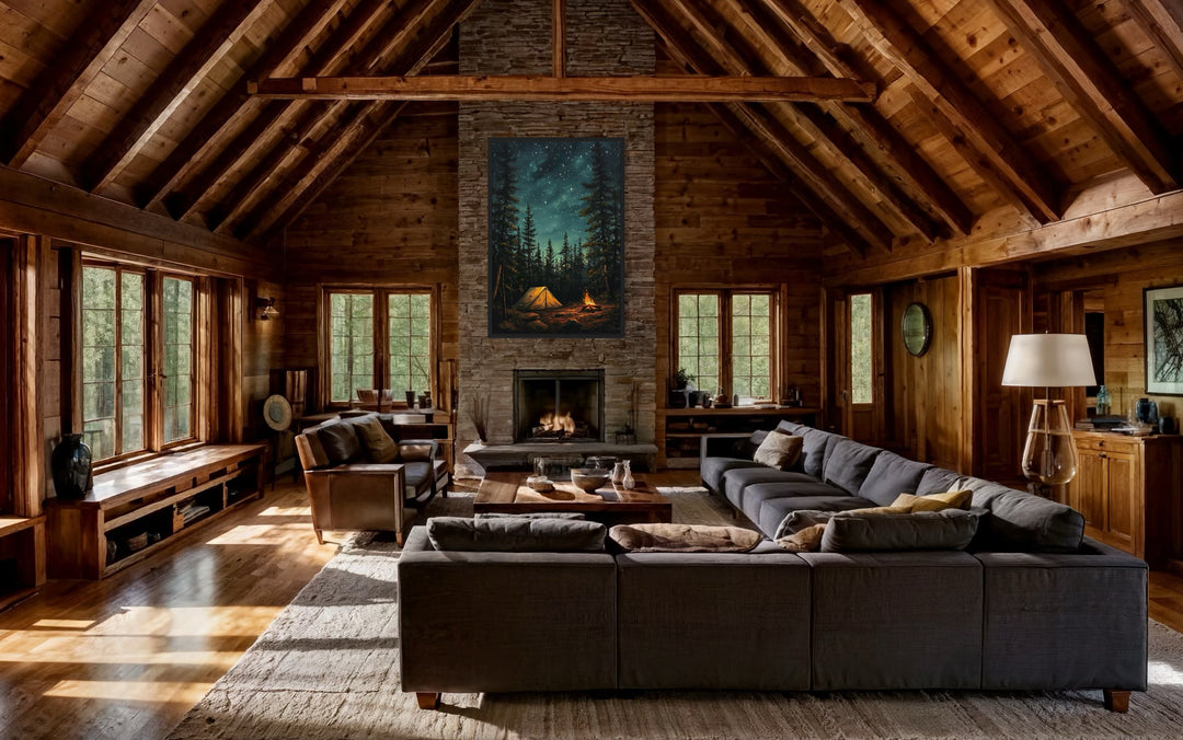 Campfire and tent in pine forest canvas wall art hanging above a fireplace in a rustic cabin.
