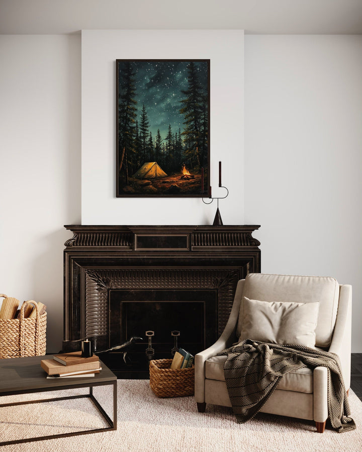 Framed canvas art of a glowing campfire and tent in a starry pine forest above a dark fireplace.