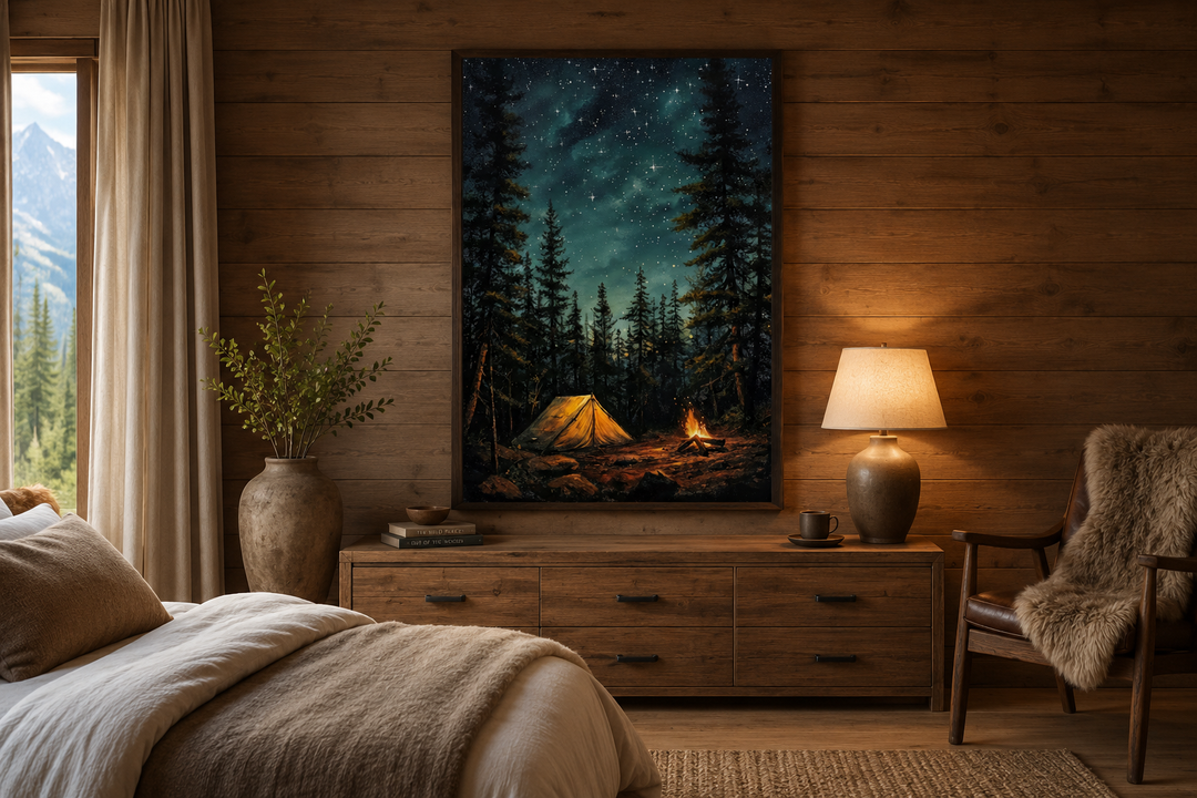 Framed canvas art of a glowing campfire and tent in a pine forest at night above a wooden dresser.