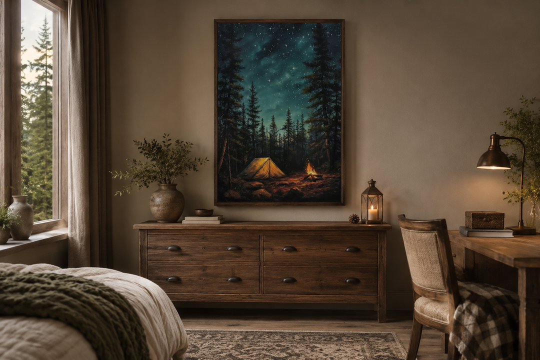 Framed canvas wall art of a glowing campfire and tent in a starry pine forest above a wooden dresser.