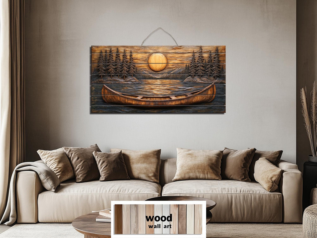 A panoramic wood wall art piece featuring a carved canoe on a lake at sunset above a tan sofa.