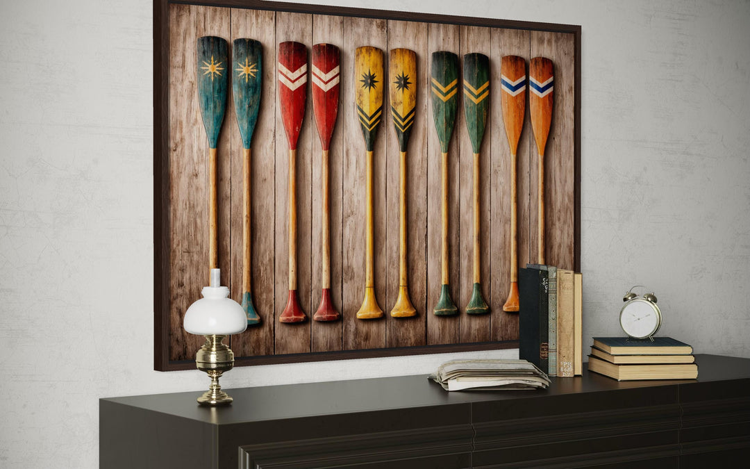 Rustic wooden canoe paddle wall art canvas print featuring colorful oars on a wood plank background.