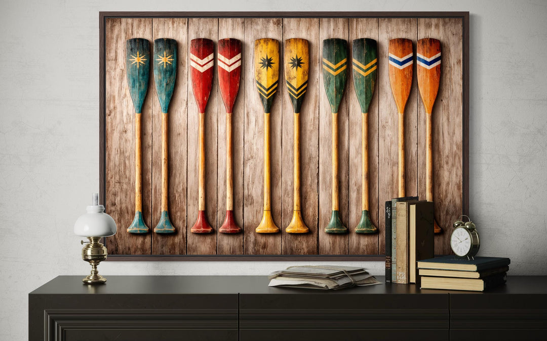 Rustic wooden canoe paddle wall art canvas print featuring colorful oars on a wood plank background.