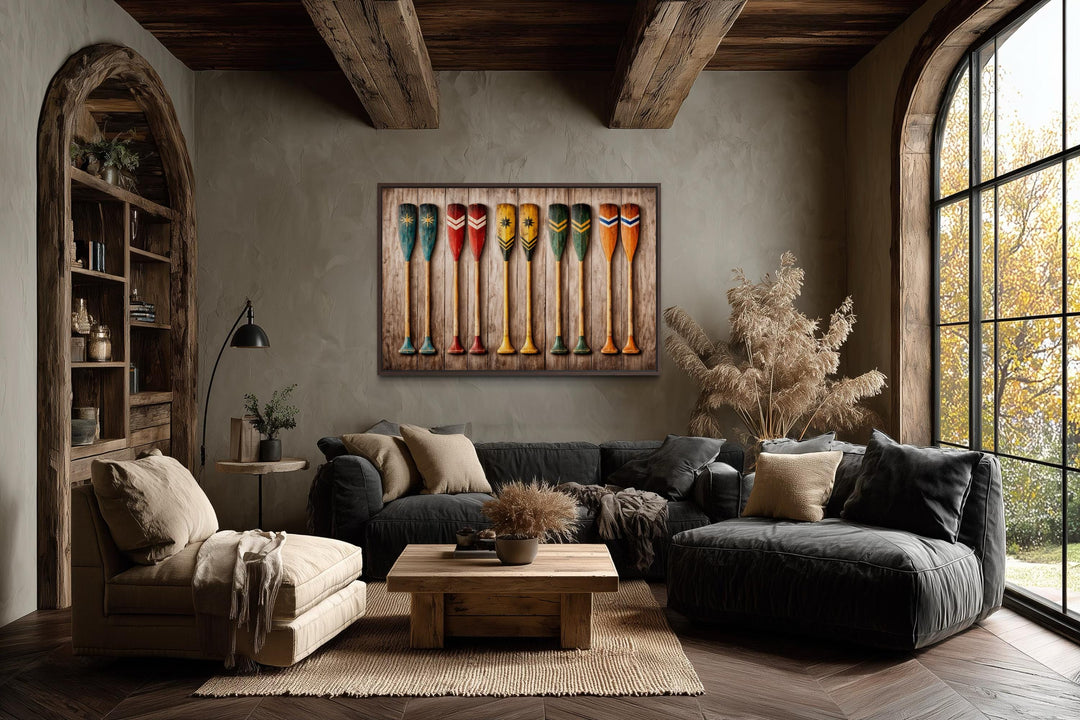 Horizontal canvas print of colorful rustic canoe paddles on a wood plank background in a cozy room.