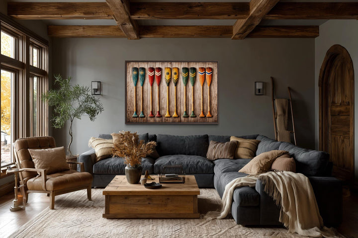 Rustic wooden canoe paddle wall art canvas print displayed in a cozy, earth-toned living room.