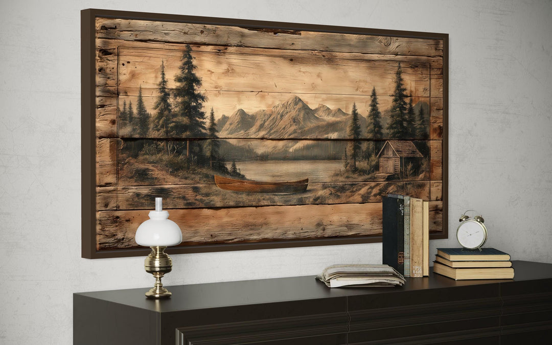 Canoe on Mountain Lake Canvas Wall Art with a rustic wood-plank effect in a dark frame.