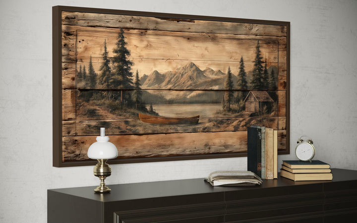 Canoe on Mountain Lake Canvas Wall Art with a rustic wood-plank effect in a dark frame.