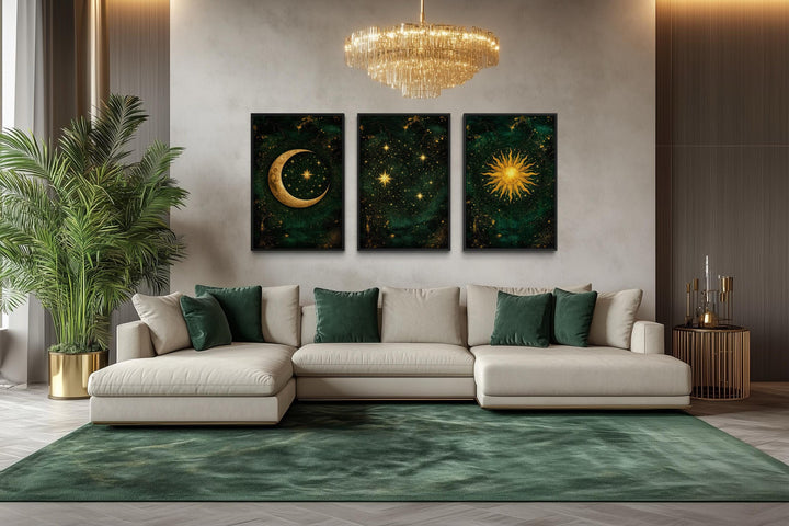 Emerald green and gold triptych canvas prints of the sun, moon, and stars above a modern sofa.