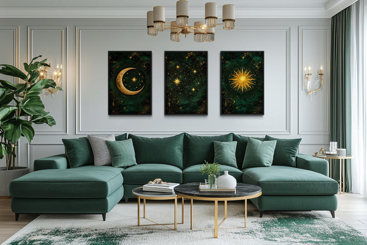 Emerald green and gold triptych canvas prints of the sun, moon, and stars above a green sofa.