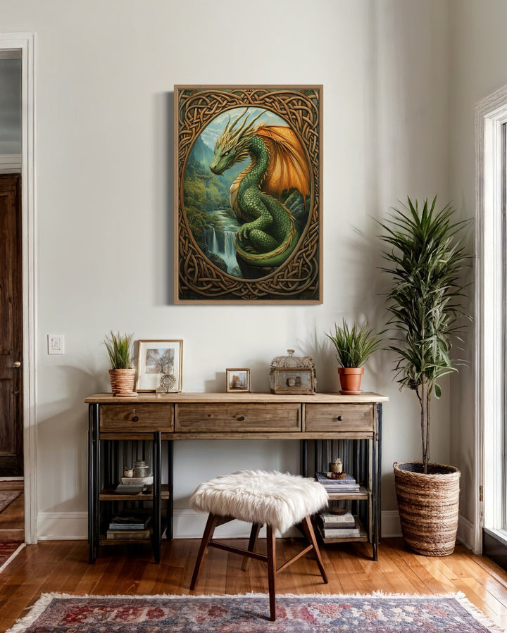Celtic dragon perched over a waterfall in a green mountain valley canvas wall art above a desk.