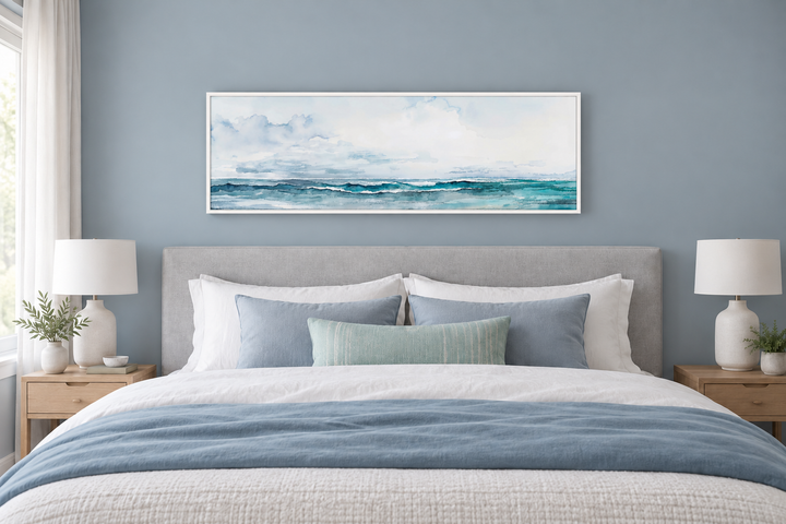 Minimalist ocean blue and gray horizontal framed canvas wall art hanging over a bed in a bedroom.