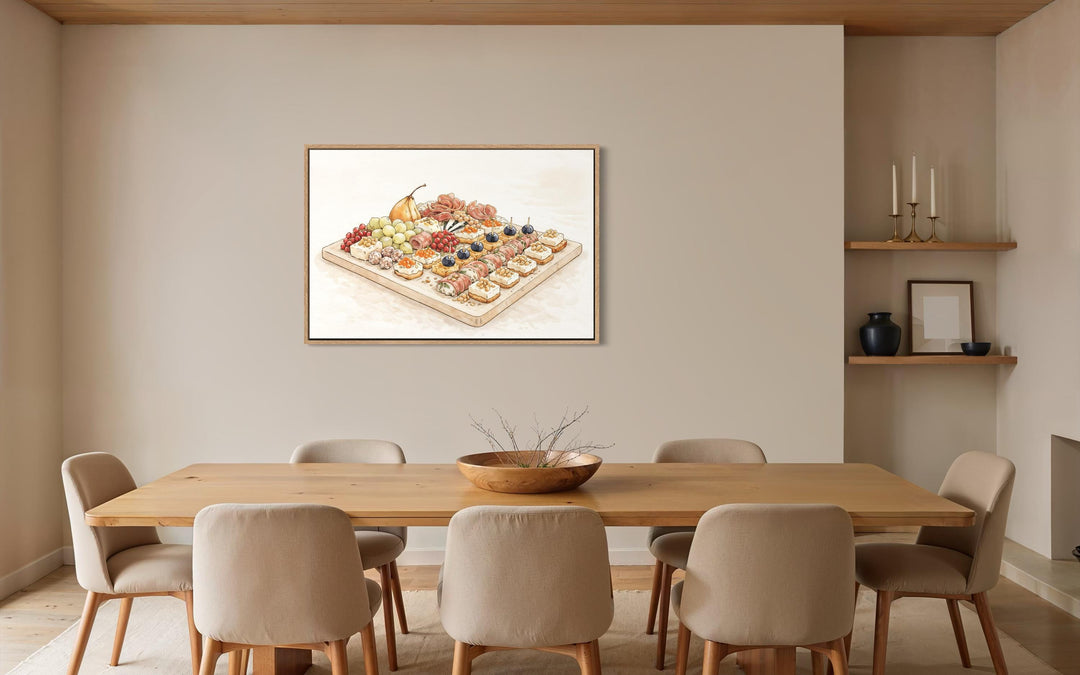 Elegant charcuterie board canvas print in a light wood frame hanging in a neutral dining room.