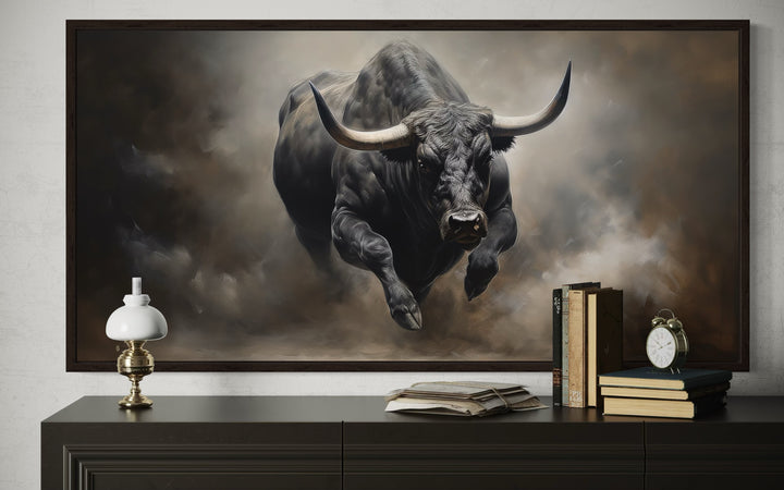Framed canvas print of a powerful black charging bull in a rustic man cave setting.