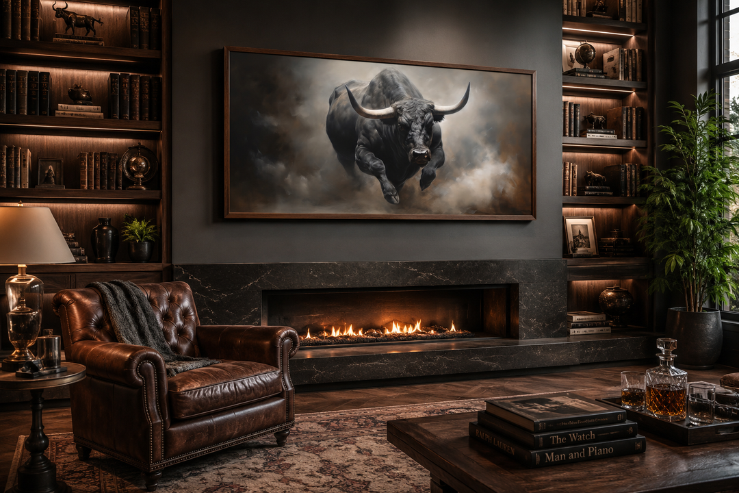 Framed charging bull canvas print hanging above a fireplace in a rustic man cave setting.