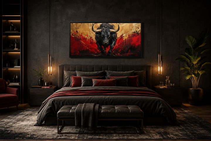 Framed canvas wall art of a charging black bull with red and gold abstract background over a bed.