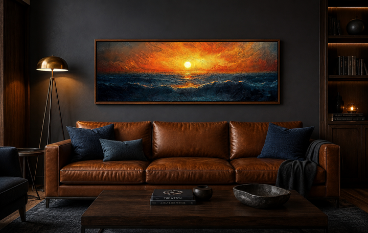 Ocean sunset long horizontal framed canvas wall art hanging above a brown leather sofa.