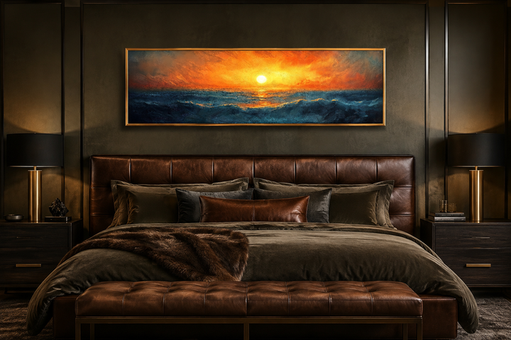 Ocean sunset long horizontal framed canvas wall art hanging above a leather headboard in a bedroom.
