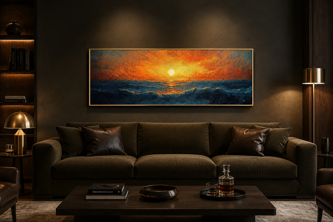 Ocean sunset long horizontal framed canvas wall art hanging above a dark brown sofa in a living room.