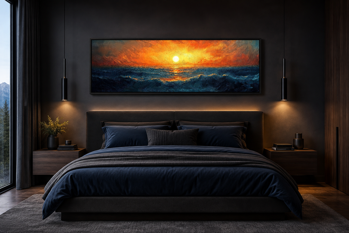Framed horizontal canvas wall art of a vibrant orange sunset over blue ocean waves above a bed.