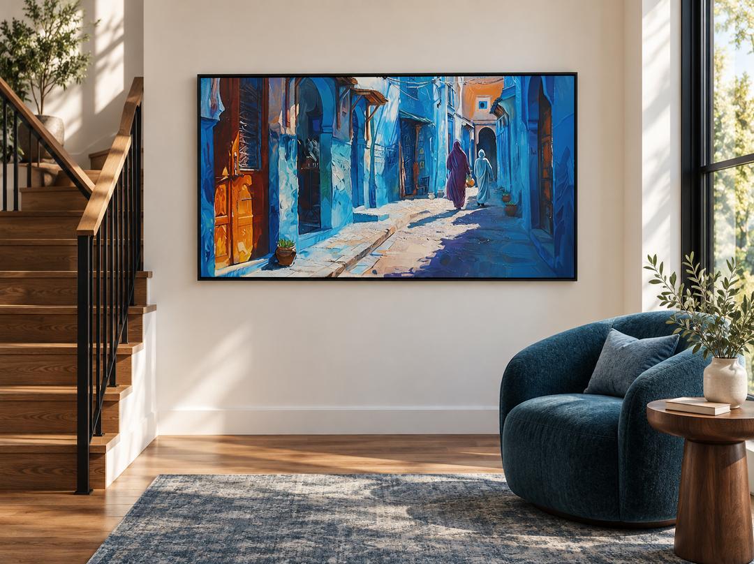 Framed canvas wall art of a vibrant blue Moroccan street scene in a modern living room setting.