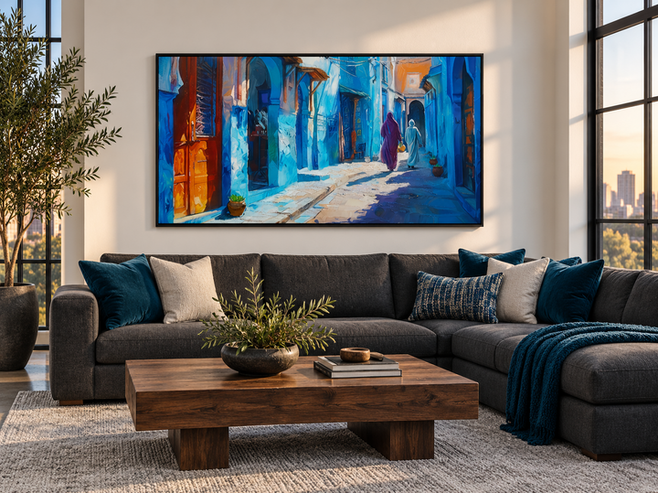 Chefchaouen Blue Street Painting Morocco framed canvas wall art above a dark gray sectional sofa.