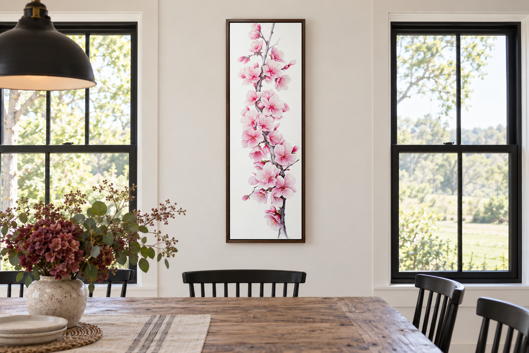 Vertical framed watercolor cherry blossom canvas art hanging in a farmhouse dining room.
