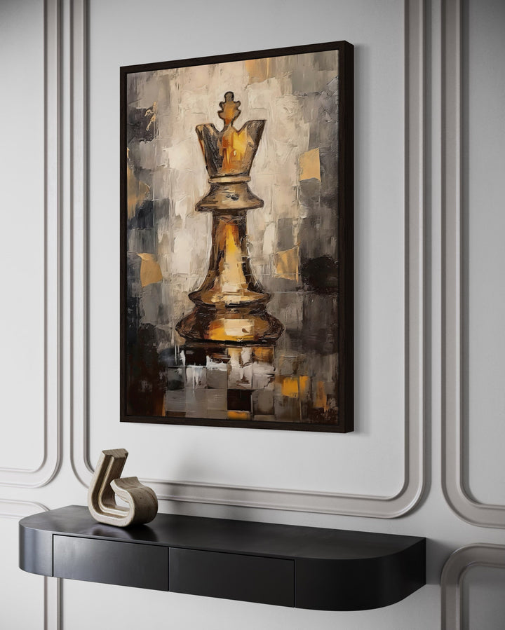 Chess King framed canvas wall art in black and gold abstract style hanging above a black console.