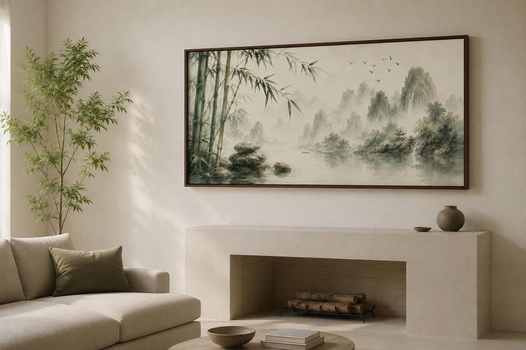 Chinese landscape canvas print of misty mountains and bamboo in sage green above a fireplace.