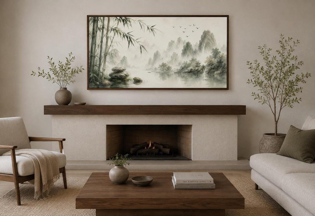 Chinese landscape wall art with bamboo and misty mountains above a fireplace in a zen living room.