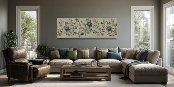 Chinoiserie floral botanical blue and beige long horizontal wall art above a modern sofa.