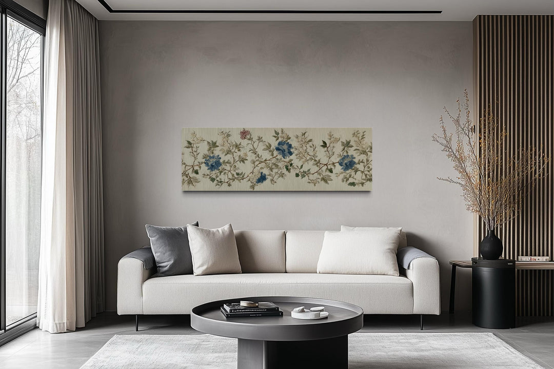Chinoiserie floral botanical blue and beige long horizontal wall art above a modern sofa.