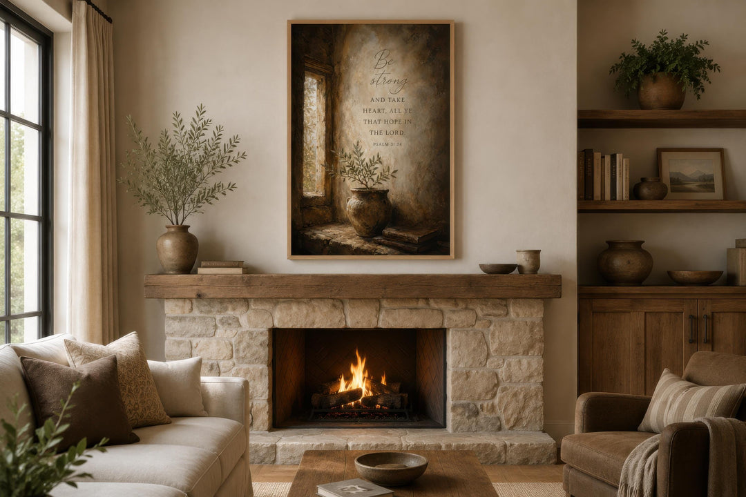 Psalm 31:24 scripture canvas art above a stone fireplace in a warm, rustic living room.