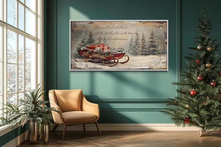 Framed canvas wall art of Santa's sleigh with gifts and a Christmas blessing in a green room.
