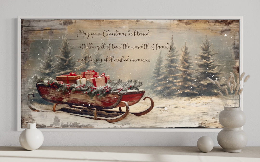 Framed canvas art of a red sleigh with gifts in a snowy forest with a Christmas blessing message.