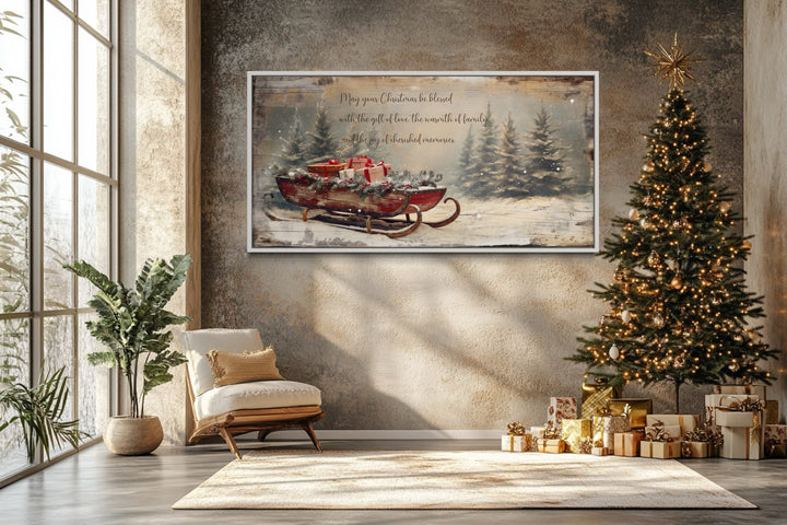 Framed canvas wall art of Santa's sleigh with gifts and a Christmas blessing in a cozy room.