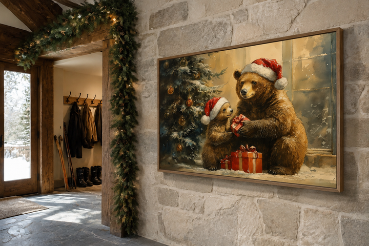 Mama bear and cub in Santa hats exchanging gifts, framed Christmas wall art on a stone wall.