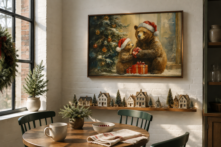 Mama bear and cub in Santa hats exchange gifts in a framed Christmas wall art above a table.