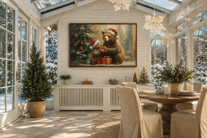 Mama bear and cub in Santa hats exchanging gifts on a framed canvas wall art in a sunroom.