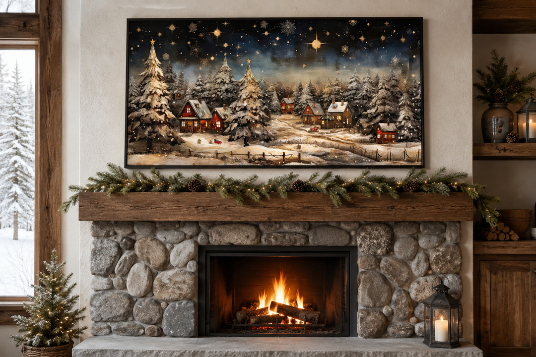 Snowy winter village painting at night displayed above a stone fireplace with a lit fire.