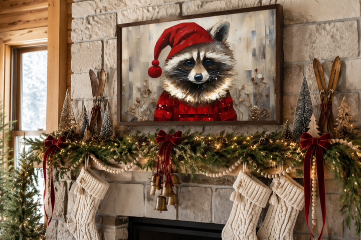 Framed canvas wall art of a raccoon in a Santa hat displayed above a decorated Christmas mantel.