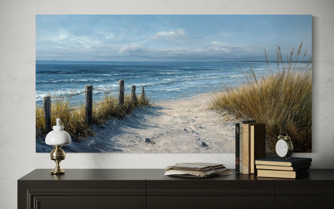 Horizontal canvas print of a serene beach path with dunes and ocean waves above a dark console.