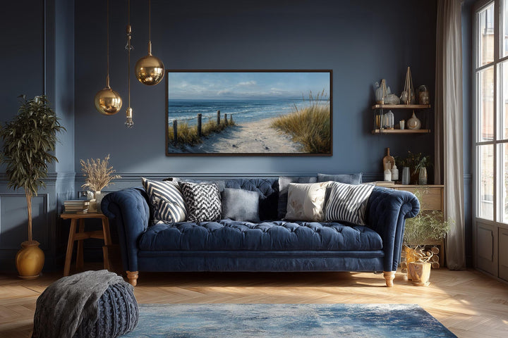 Horizontal coastal beach wall art featuring a sandy path to the ocean in a blue living room.