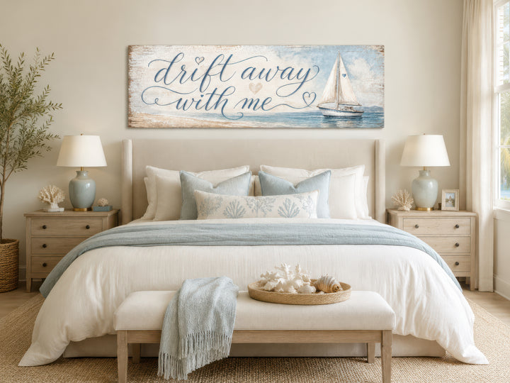 Coastal bedroom wall art featuring a sailboat and 'Drift away with me' text on light blue canvas.