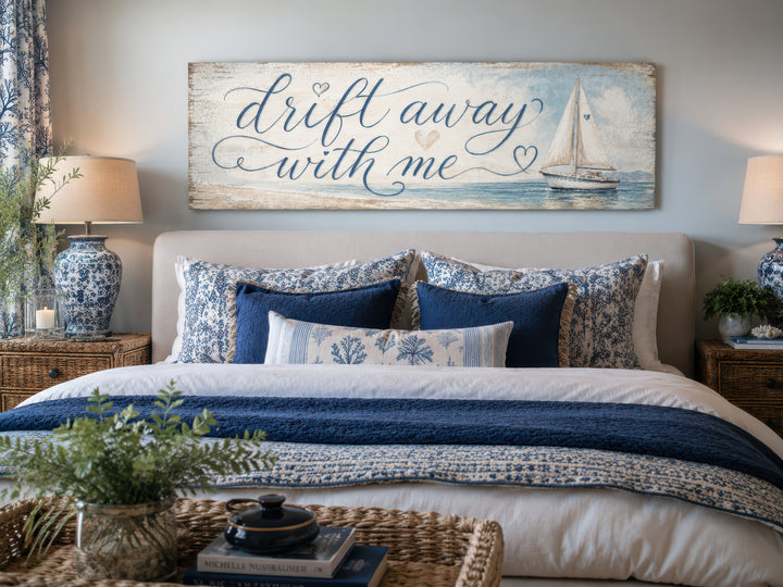 Coastal bedroom sign with sailboat on light blue canvas wall art above a blue and white bed.