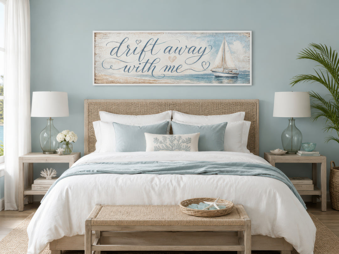 Coastal bedroom sign with sailboat and "Drift away with me" text on light blue canvas wall art.