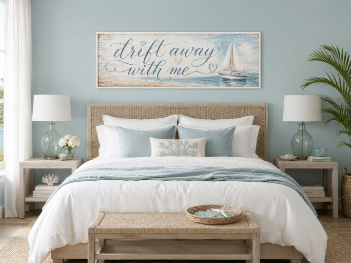 Coastal bedroom sign with sailboat and "Drift away with me" text on light blue canvas wall art.