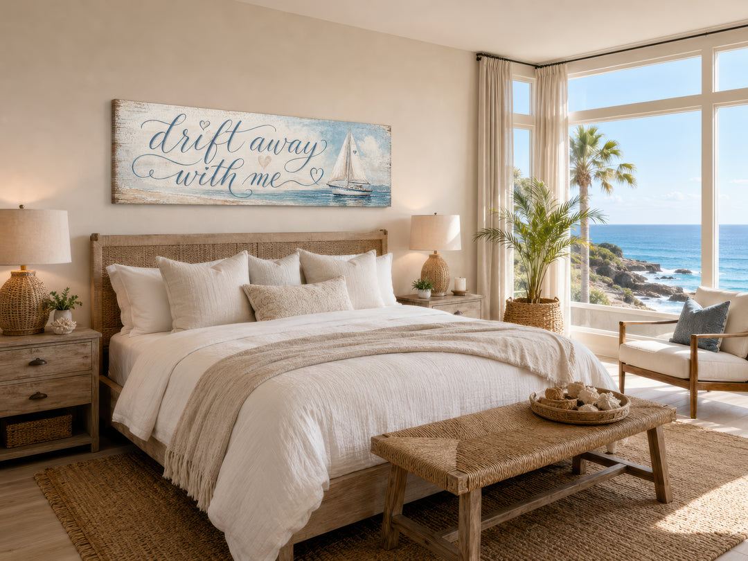 Coastal bedroom sign with sailboat on light blue canvas wall art above a bed in a beach house.