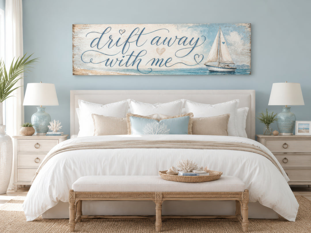 Coastal bedroom wall art featuring a sailboat and 'Drift away with me' text on light blue canvas.